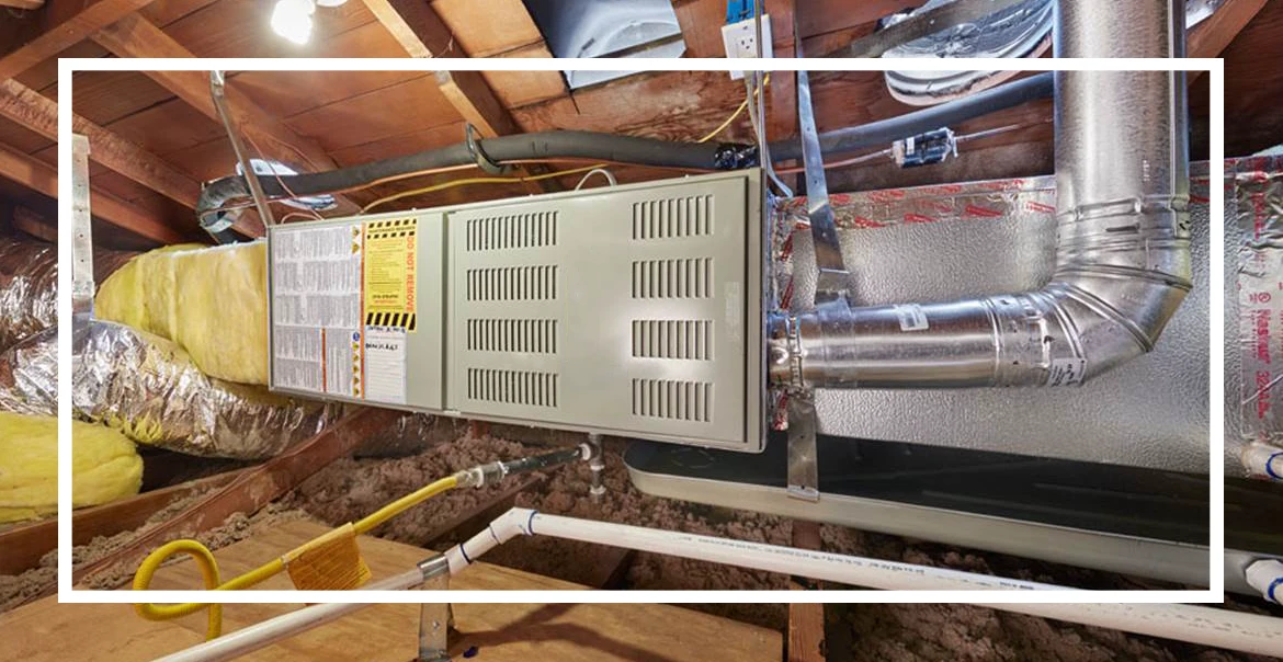 Furnace installed in attic with ductwork and insulation