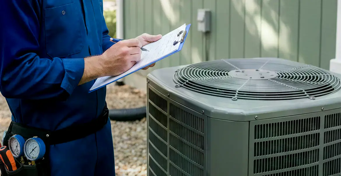 HVAC technician inspecting an outdoor air conditioning unit