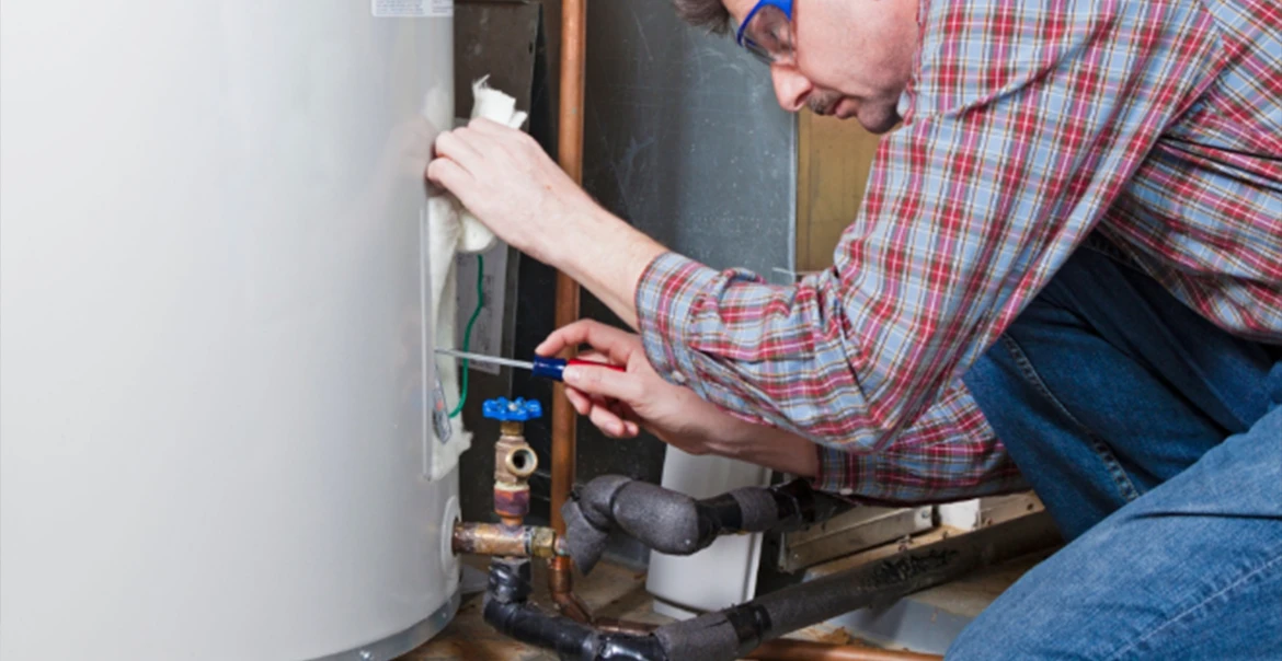 Technician servicing a residential water heater.