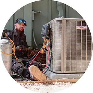 Technicians installing a free air conditioner as part of the Feel the Love program